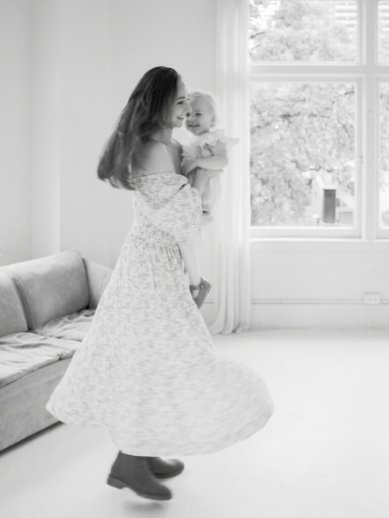 Mom holding her daughter while dancing during a family session in a studio in Vancouver, BC