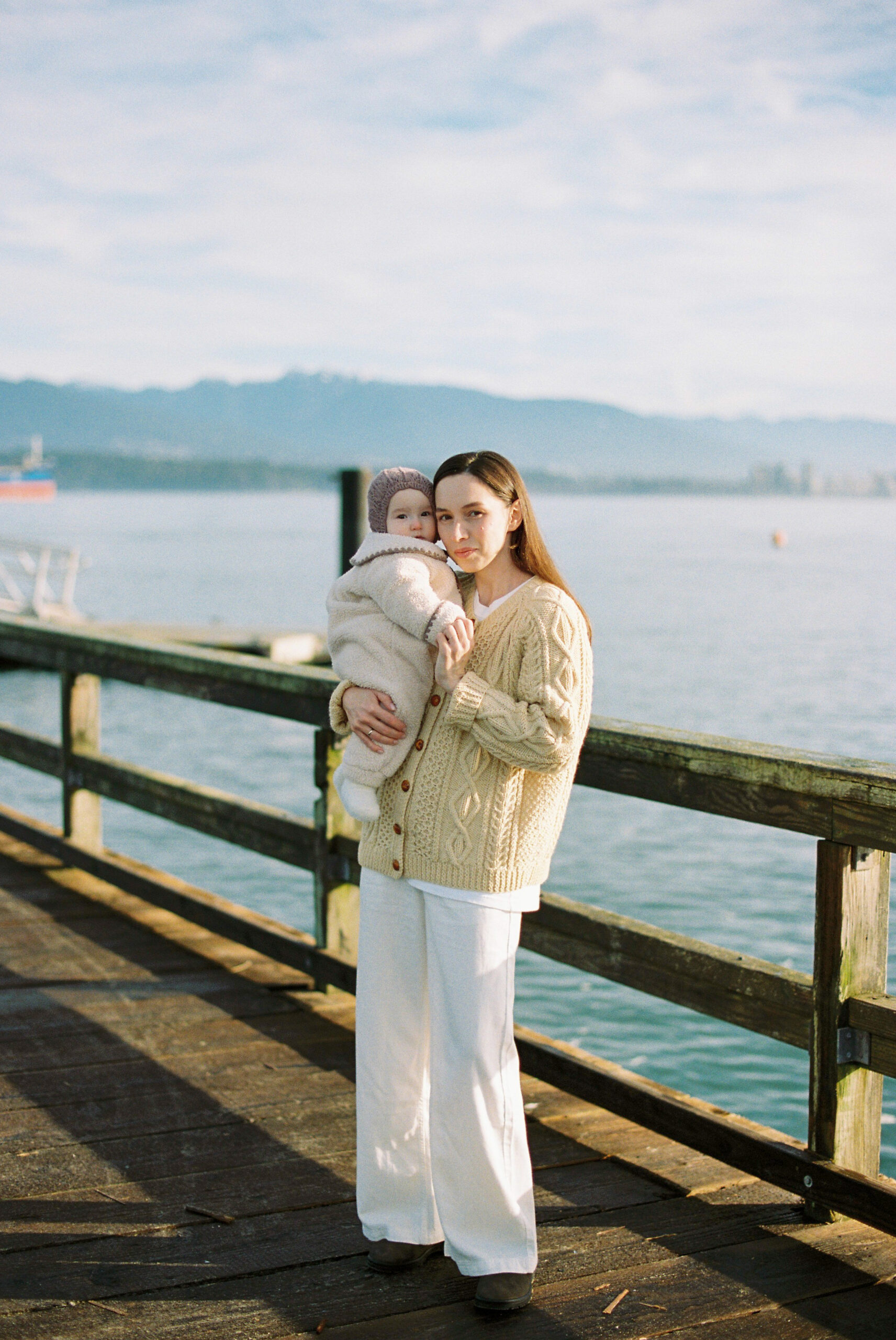 Mom and baby on the pier at Jericho Beach in Vancouver posing for a portrait